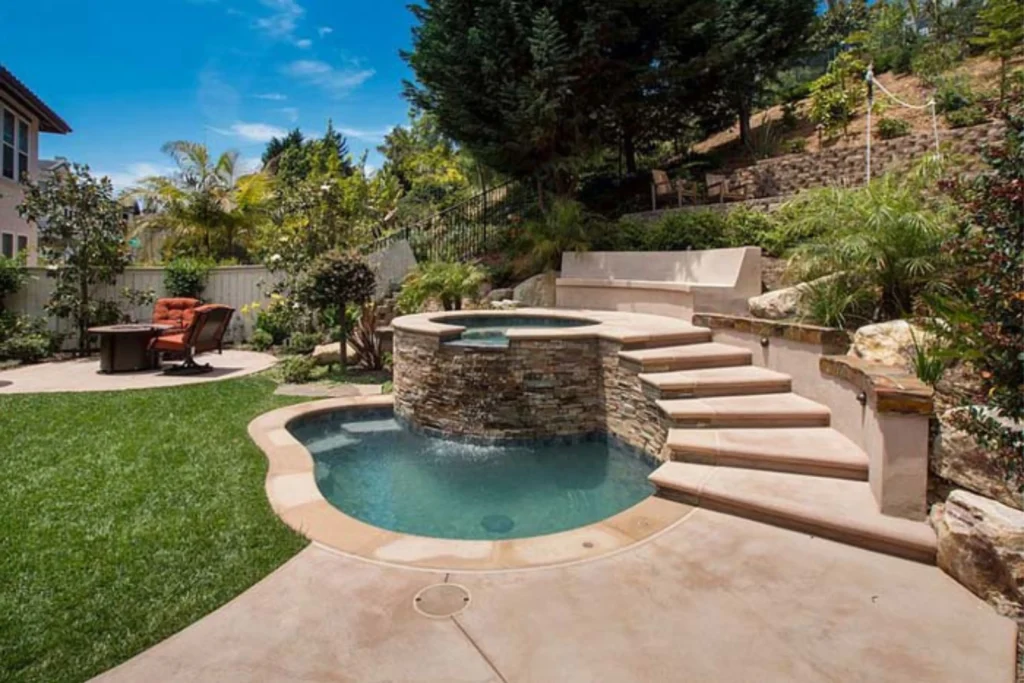 Scenic Spa Area Features Waterfall and Concrete Bench Steps